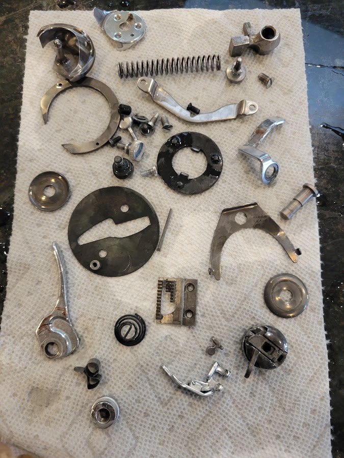 Small components laid out after cleaning, ready for reassembly.